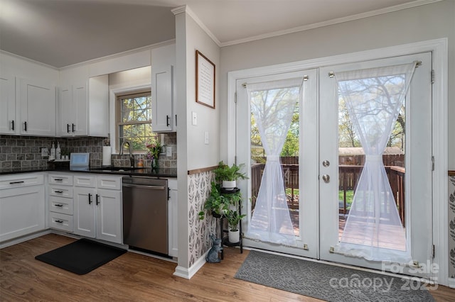 entryway featuring crown molding, french doors, dark wood-style flooring, and a sink