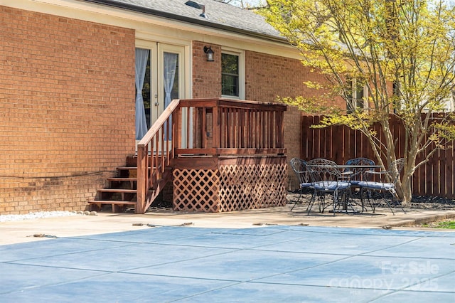 exterior space featuring a patio area, a fenced in pool, and fence