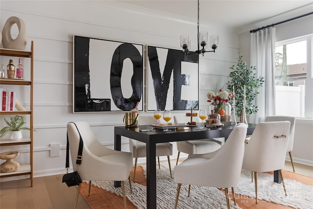 dining room with a notable chandelier and wood finished floors