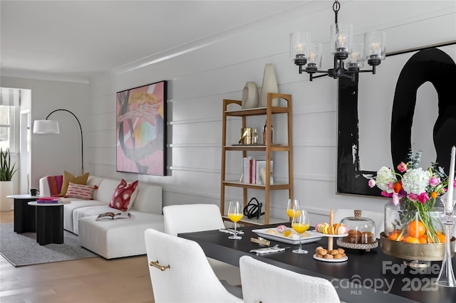 dining space with a notable chandelier and wood finished floors