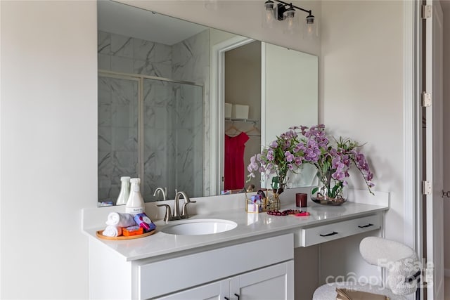 bathroom with a marble finish shower and vanity