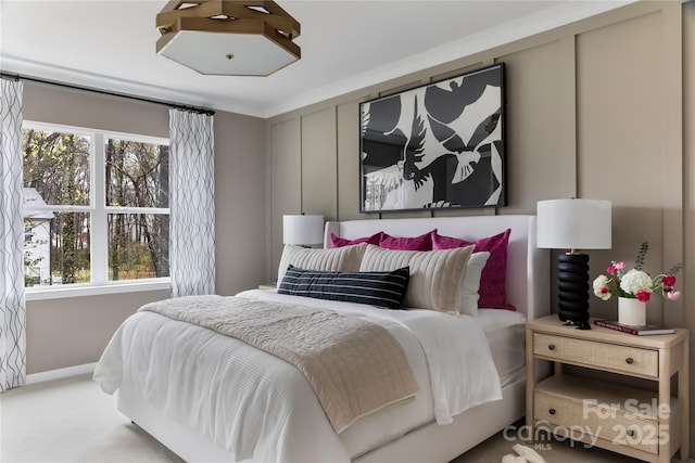 bedroom featuring baseboards and carpet