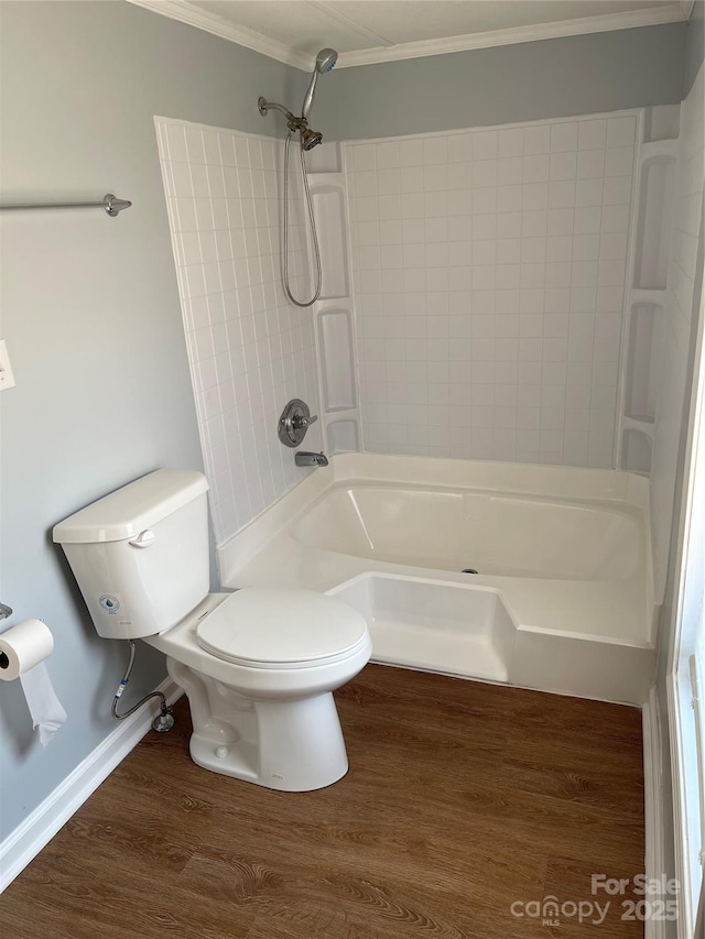 full bath with wood finished floors, baseboards, shower / bathing tub combination, crown molding, and toilet