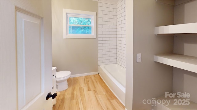 bathroom featuring baseboards, toilet, and wood finished floors