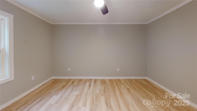 empty room featuring ceiling fan, wood finished floors, baseboards, and ornamental molding