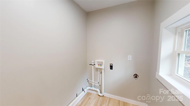 laundry area with laundry area, hookup for a washing machine, plenty of natural light, and light wood-type flooring