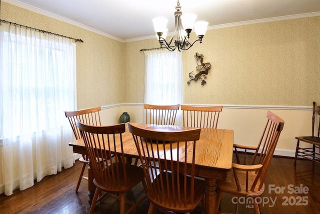 dining space with wallpapered walls, an inviting chandelier, wood finished floors, and ornamental molding