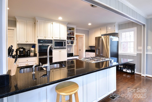 kitchen featuring crown molding, dark wood-type flooring, appliances with stainless steel finishes, white cabinetry, and open shelves