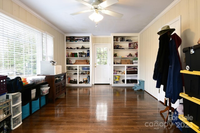 interior space with wood finished floors, plenty of natural light, and ornamental molding