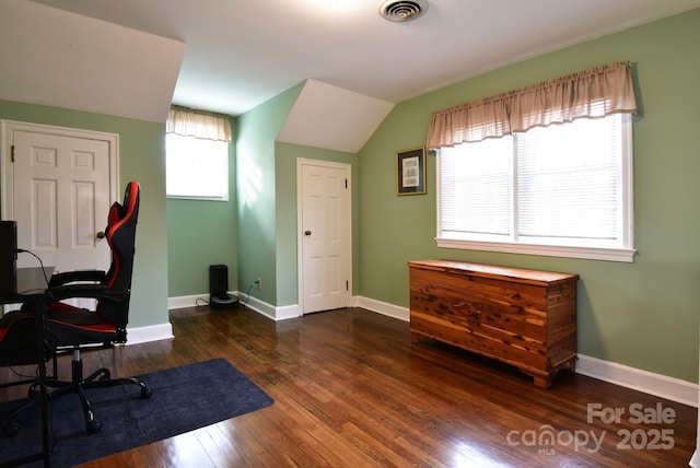 office space featuring visible vents, lofted ceiling, baseboards, and wood-type flooring