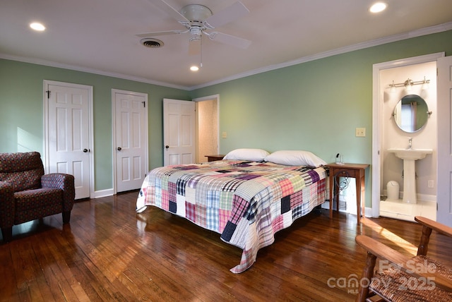 bedroom featuring visible vents, ornamental molding, two closets, and dark wood-style flooring