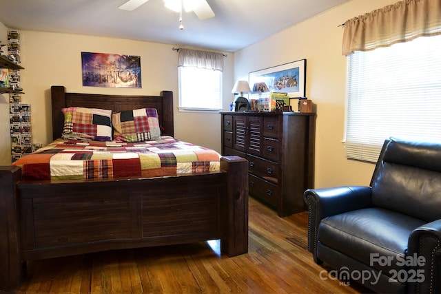 bedroom with hardwood / wood-style floors and a ceiling fan