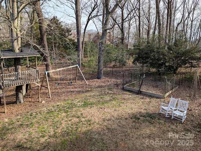 view of yard featuring a garden and a playground