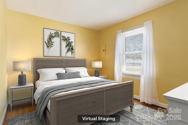 bedroom featuring wood finished floors and baseboards