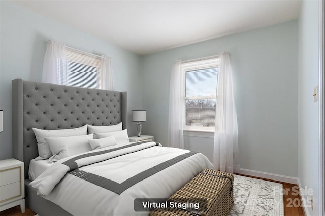 bedroom featuring wood finished floors and baseboards