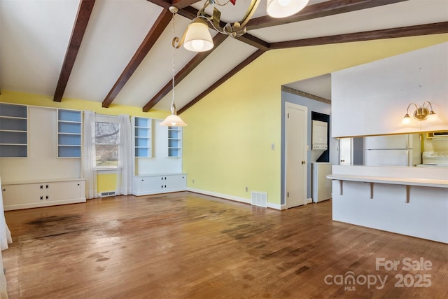 unfurnished living room with visible vents, baseboards, wood finished floors, and vaulted ceiling with beams