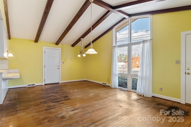 unfurnished living room featuring visible vents, baseboards, wood finished floors, and vaulted ceiling with beams