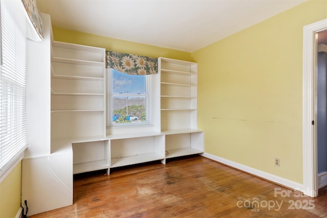 interior space with baseboards and hardwood / wood-style floors