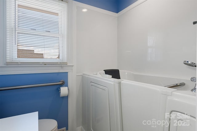 full bathroom with toilet and a bathing tub