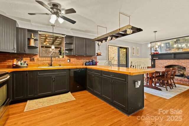 kitchen featuring a sink, wooden counters, black dishwasher, a peninsula, and open shelves