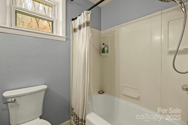 bathroom with toilet and shower / tub combo with curtain