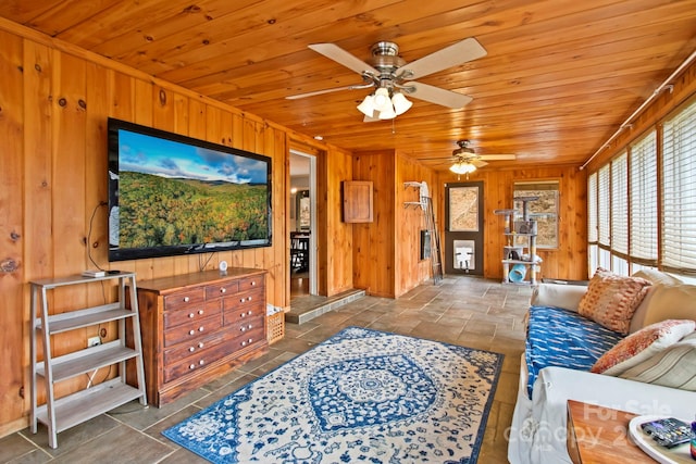 living room featuring wooden ceiling, wooden walls, and stone tile floors