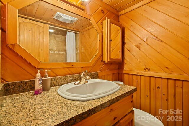 full bathroom with vanity, wooden walls, visible vents, curtained shower, and wooden ceiling