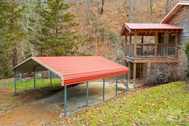 view of yard with a carport and a wooded view