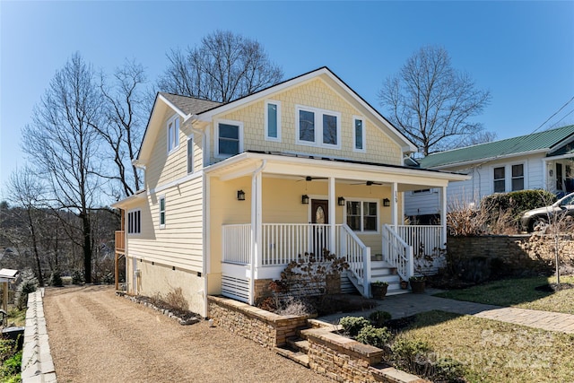 view of front of home with covered porch, dirt driveway, and ceiling fan