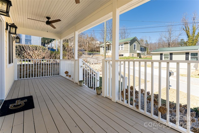 deck with a residential view and ceiling fan