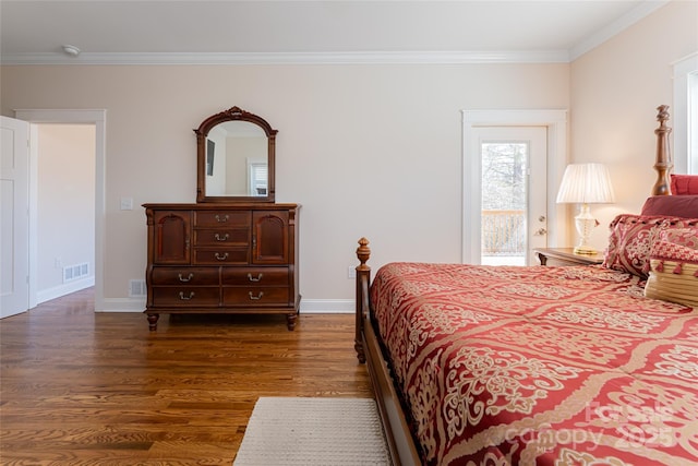 bedroom with crown molding, visible vents, dark wood-style flooring, and baseboards