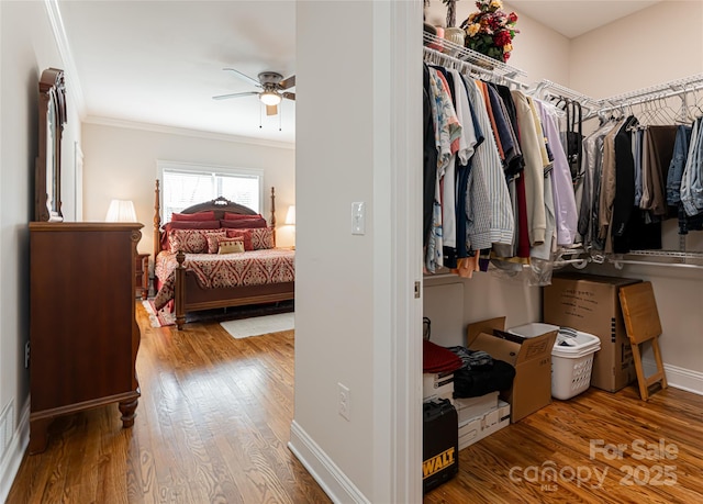 walk in closet featuring ceiling fan and wood finished floors