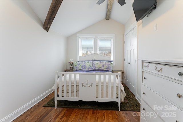 bedroom featuring wood finished floors, a closet, baseboards, ceiling fan, and vaulted ceiling with beams