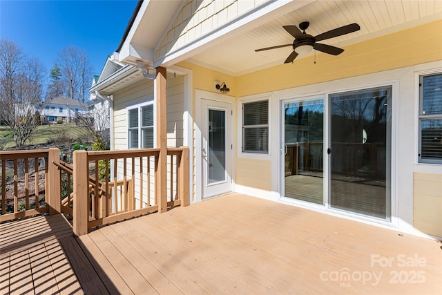 wooden deck with a ceiling fan