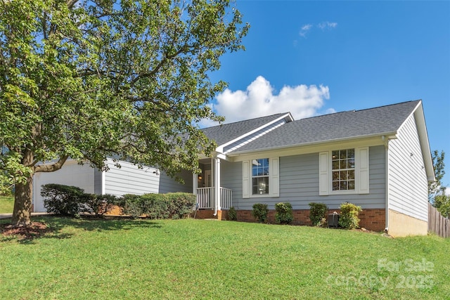 single story home with a garage, a front lawn, and roof with shingles