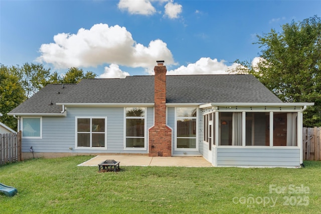 back of house with a lawn, a shingled roof, fence, a sunroom, and a chimney