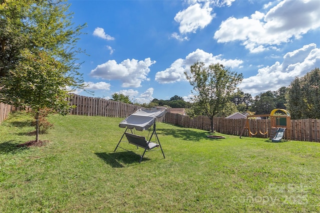 view of yard featuring a playground and a fenced backyard