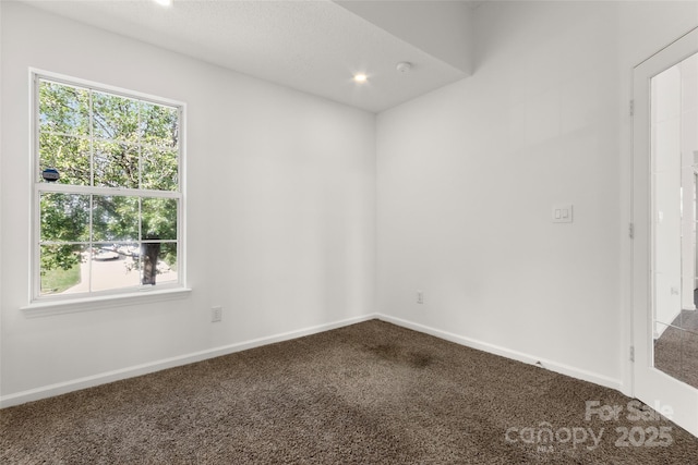 empty room with recessed lighting, baseboards, and dark carpet