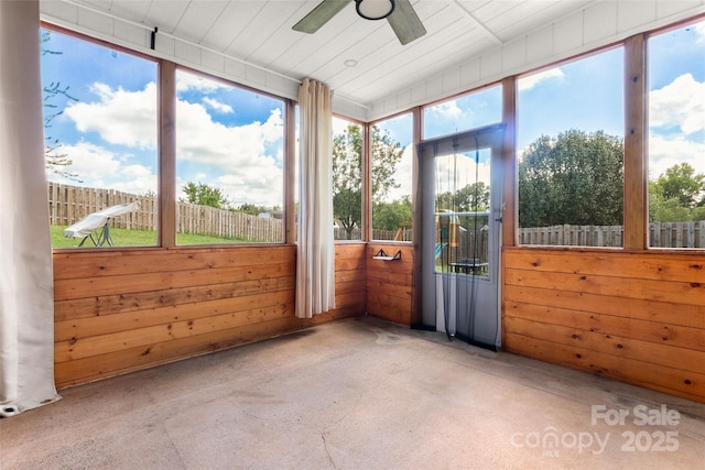 unfurnished sunroom with a ceiling fan