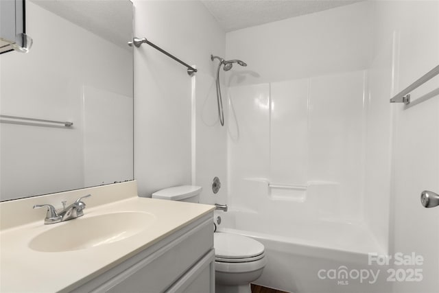 full bathroom featuring a textured ceiling, toilet, vanity, and bathtub / shower combination