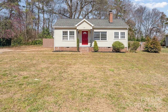 view of front facade featuring a front yard, fence, crawl space, and a shingled roof