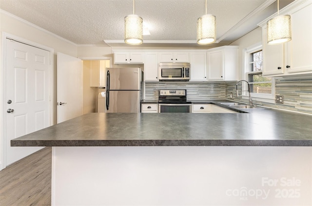 kitchen featuring a sink, dark countertops, and appliances with stainless steel finishes