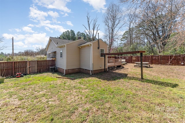 view of property exterior featuring a yard, a fenced backyard, and cooling unit