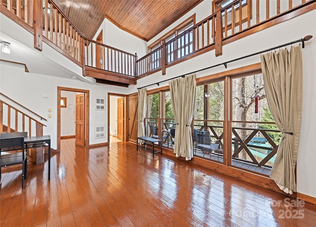 living room with wood ceiling, stairs, baseboards, and wood-type flooring