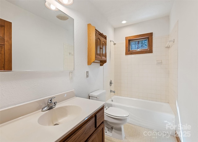 bathroom featuring tub / shower combination, toilet, and vanity