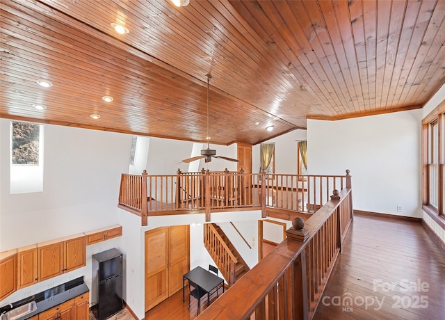 interior space featuring light wood-type flooring, recessed lighting, baseboards, wood ceiling, and vaulted ceiling