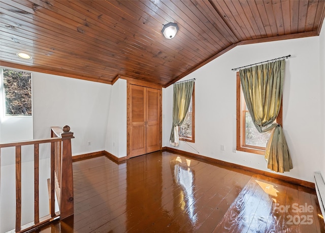 spare room featuring a wealth of natural light, wooden ceiling, lofted ceiling, and hardwood / wood-style floors