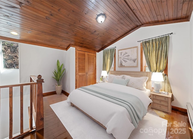 50 Cottontail Ln, Canton, NC 28716 - bedroom with lofted ceiling, baseboards, wood finished floors, wooden ceiling, and baseboard heating