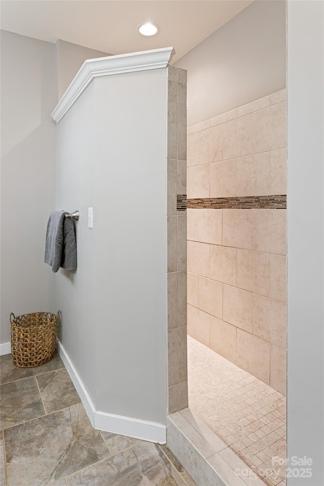 bathroom with recessed lighting, baseboards, and walk in shower