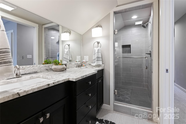 full bathroom featuring a shower stall, vanity, and lofted ceiling